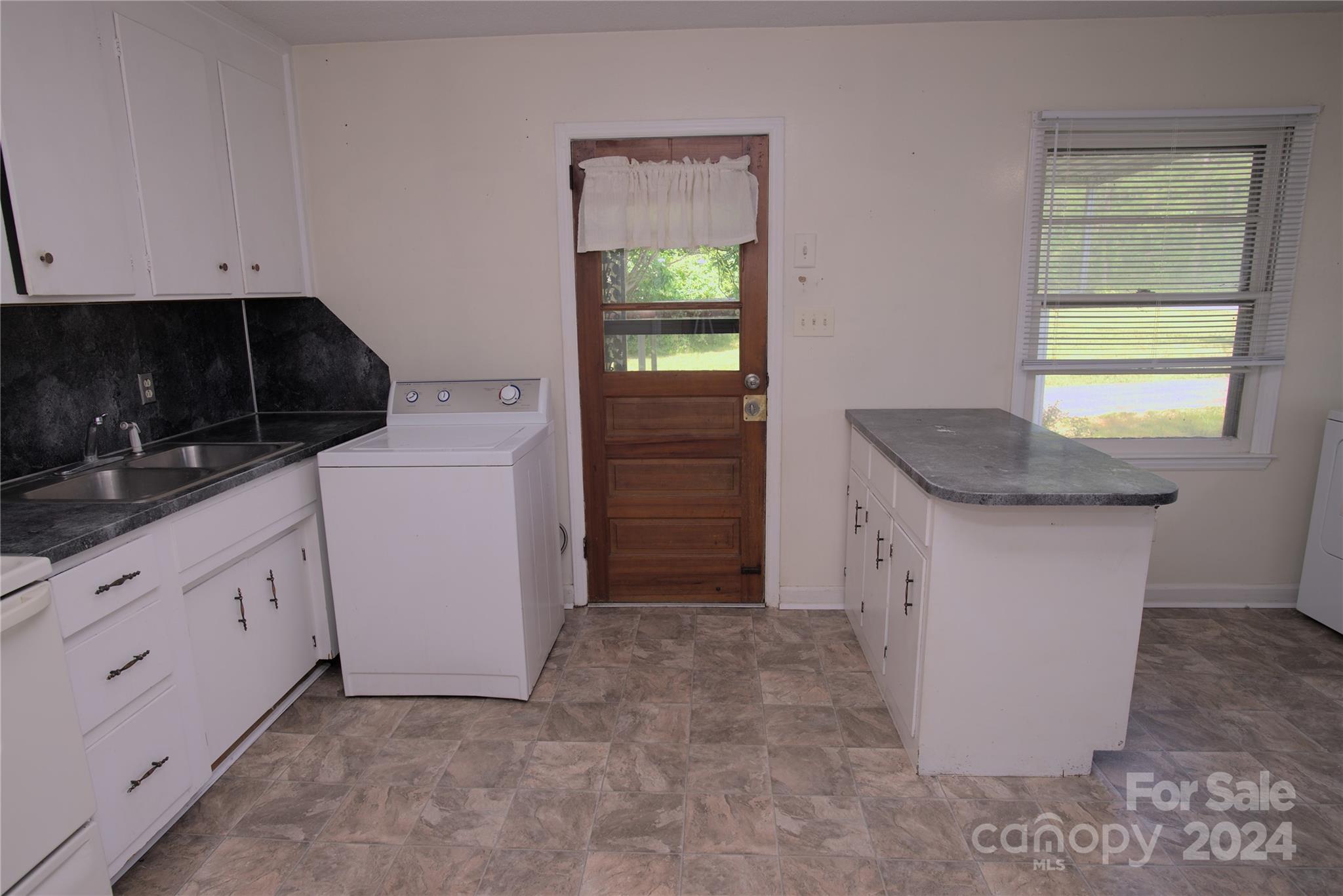 14903 Beatties Ford Road Huntersville, NC 28078 - Photo 13 of 25 a kitchen with granite countertop white cabinets and a stove