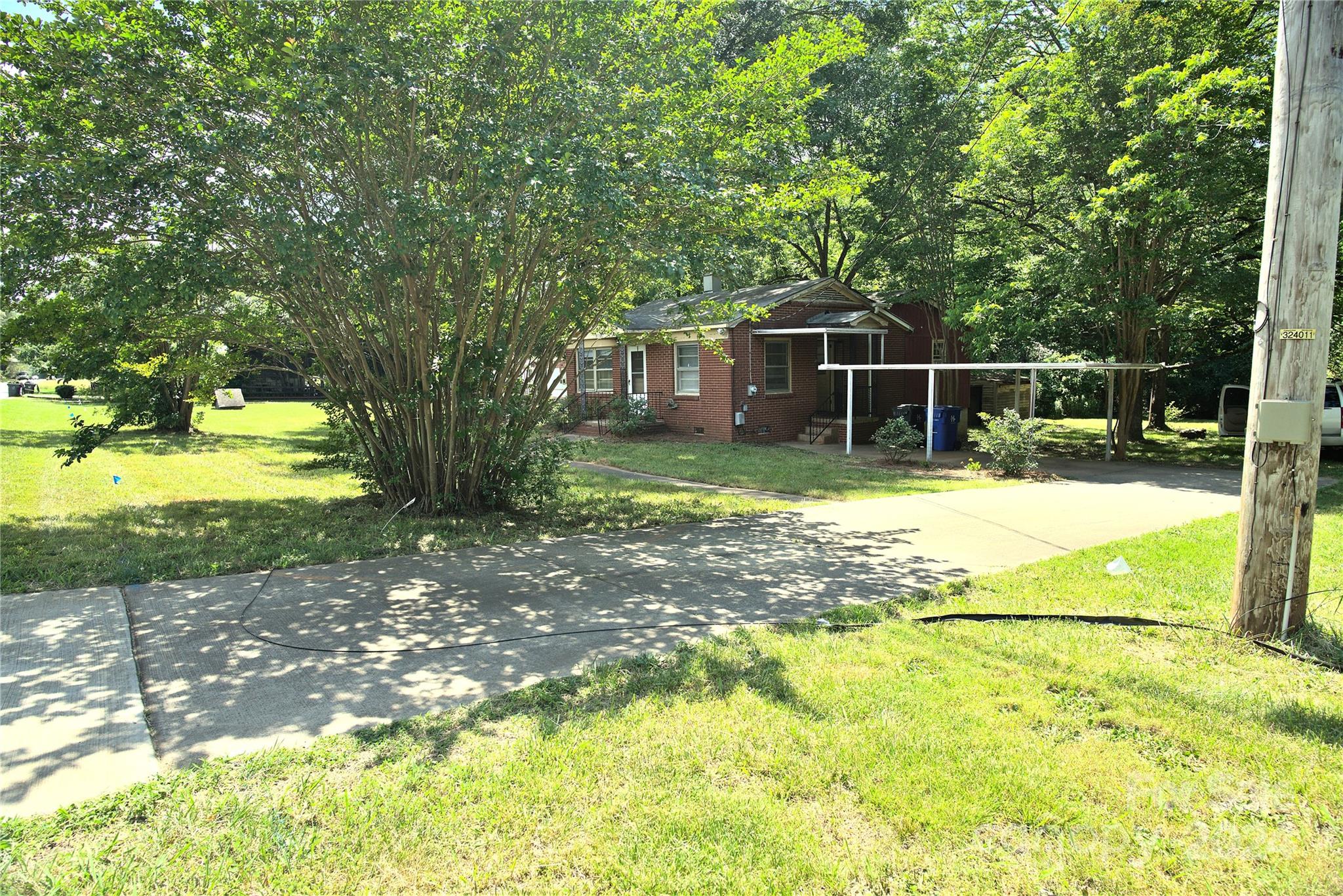 14903 Beatties Ford Road Huntersville, NC 28078 - Photo 2 of 25 a view of a backyard with swimming pool