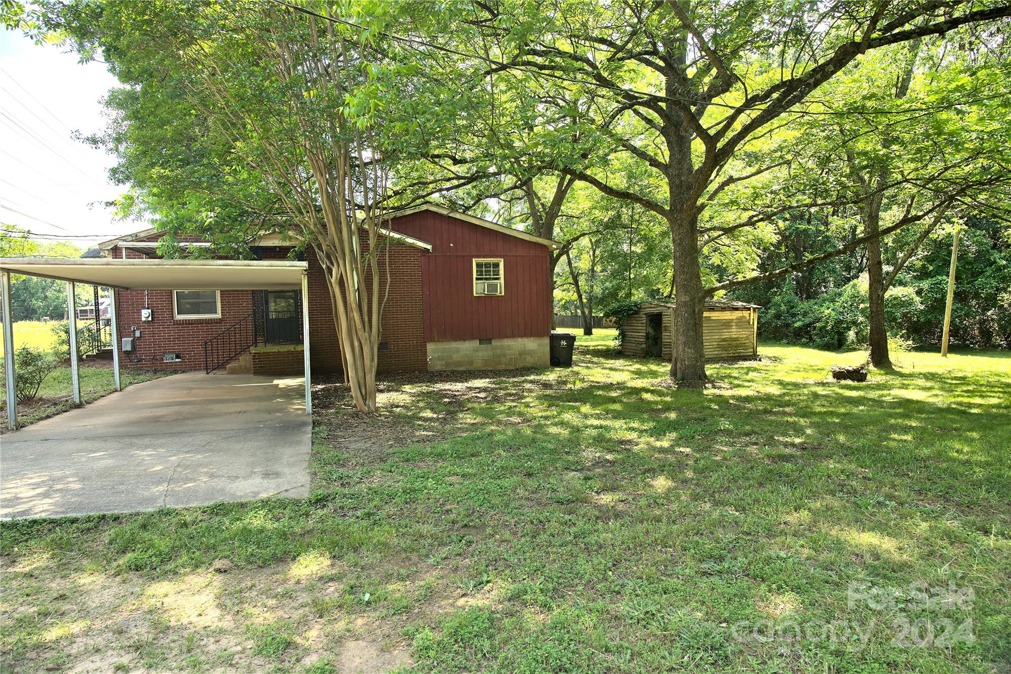 14903 Beatties Ford Road Huntersville, NC 28078 - Photo 24 of 25 a view of a house with a yard and tree s