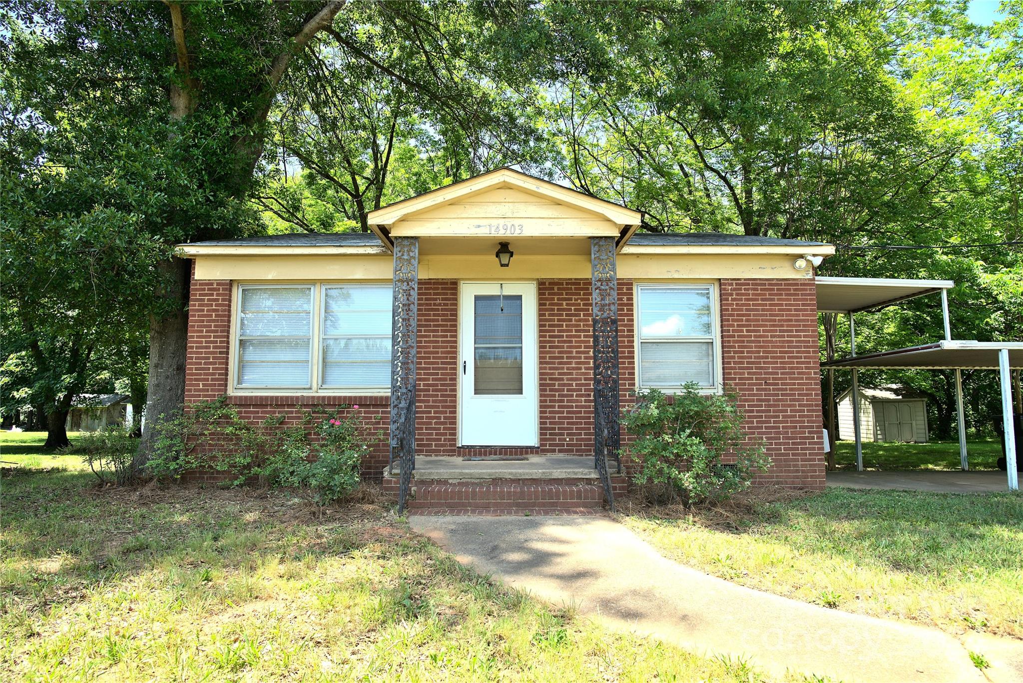 14903 Beatties Ford Road Huntersville, NC 28078 - Photo 4 of 25 a front view of a house with garden
