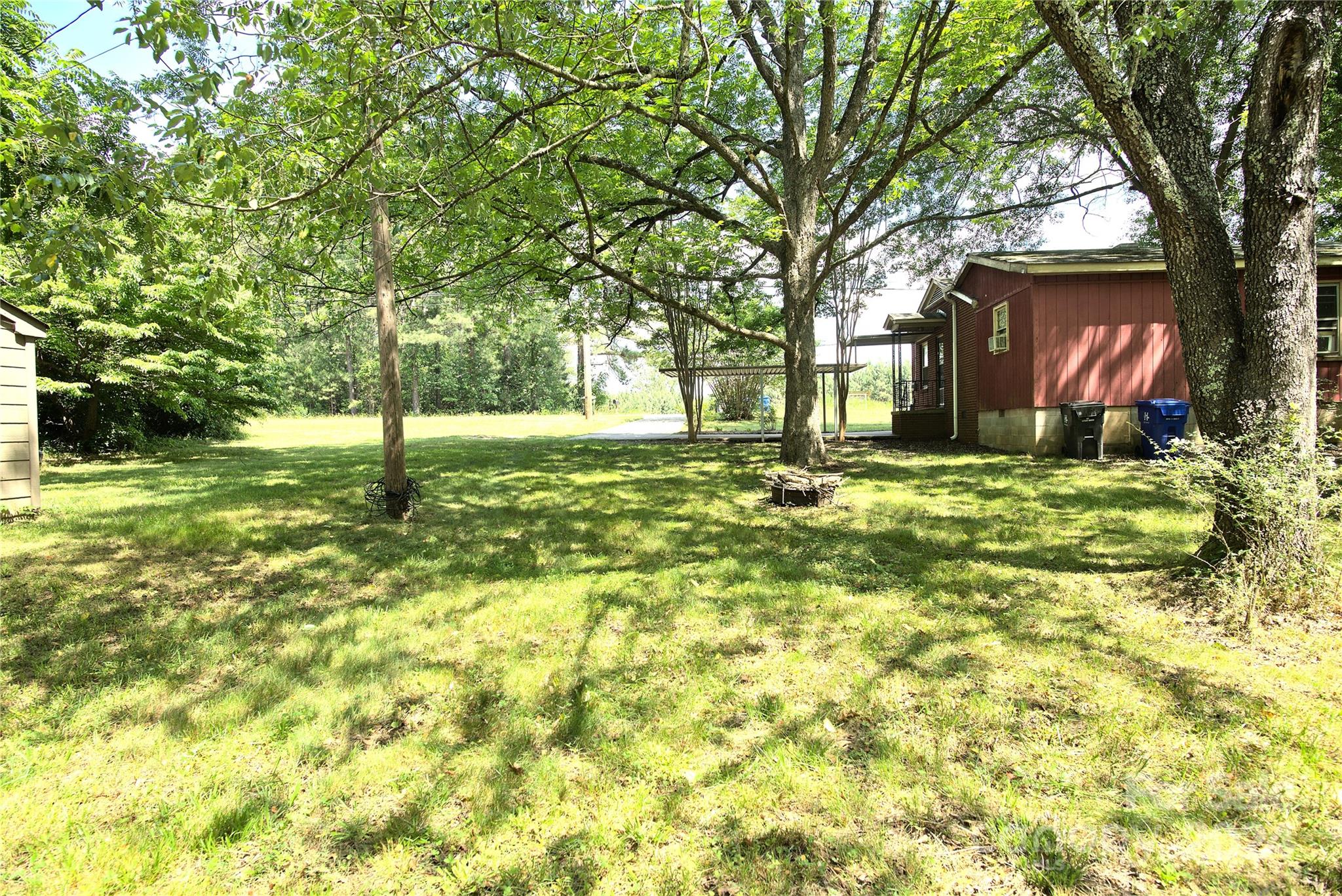 14903 Beatties Ford Road Huntersville, NC 28078 - Photo 6 of 25 a tall tree in middle of green field