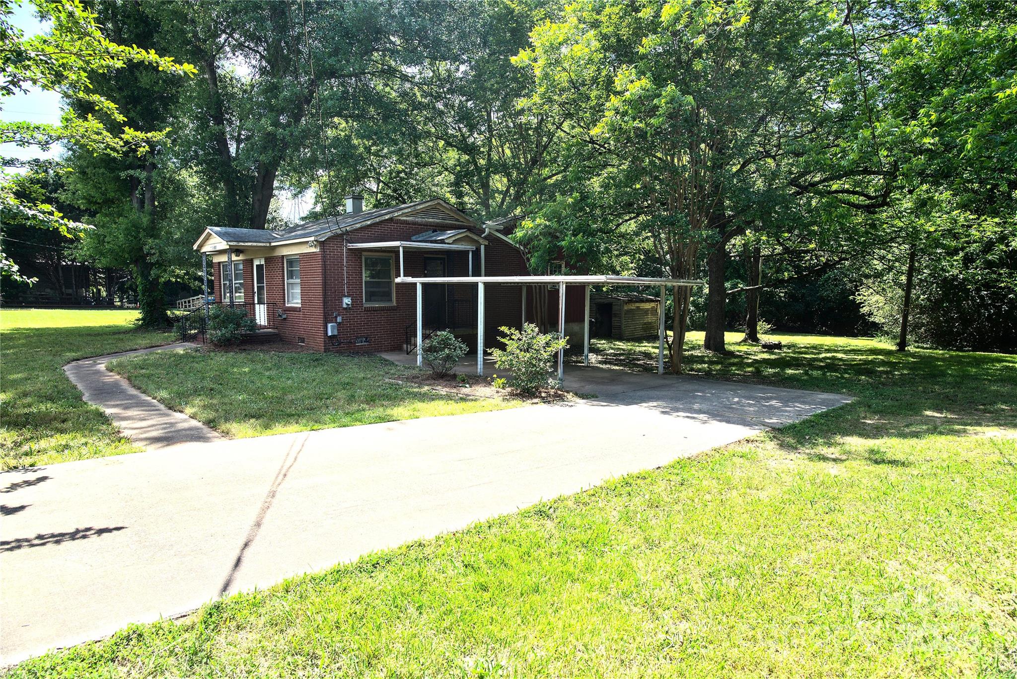 14903 Beatties Ford Road Huntersville, NC 28078 - Photo 8 of 25 a view of a house with a yard patio and tree