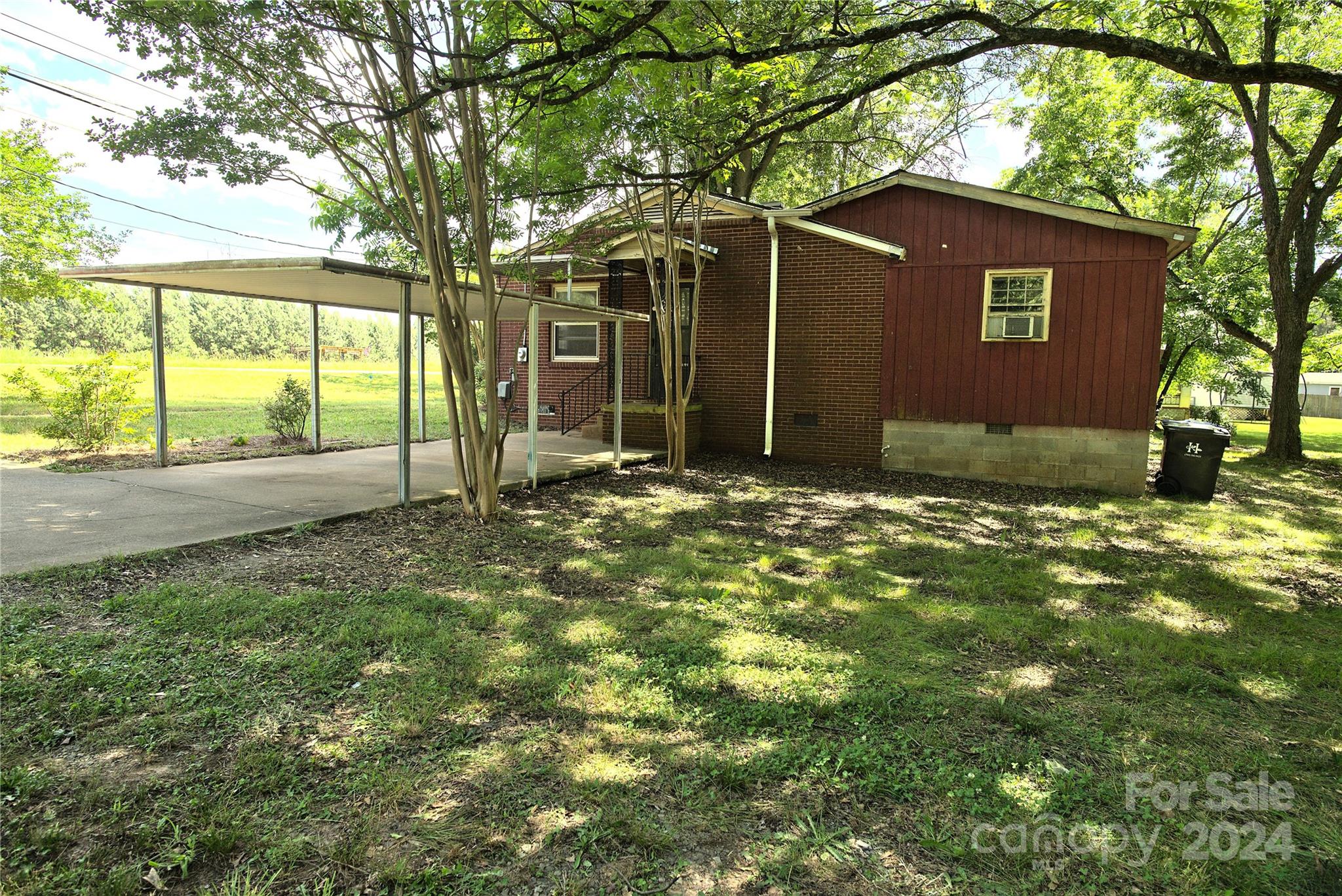 14903 Beatties Ford Road Huntersville, NC 28078 - Photo 9 of 25 a view of a yard with a tree