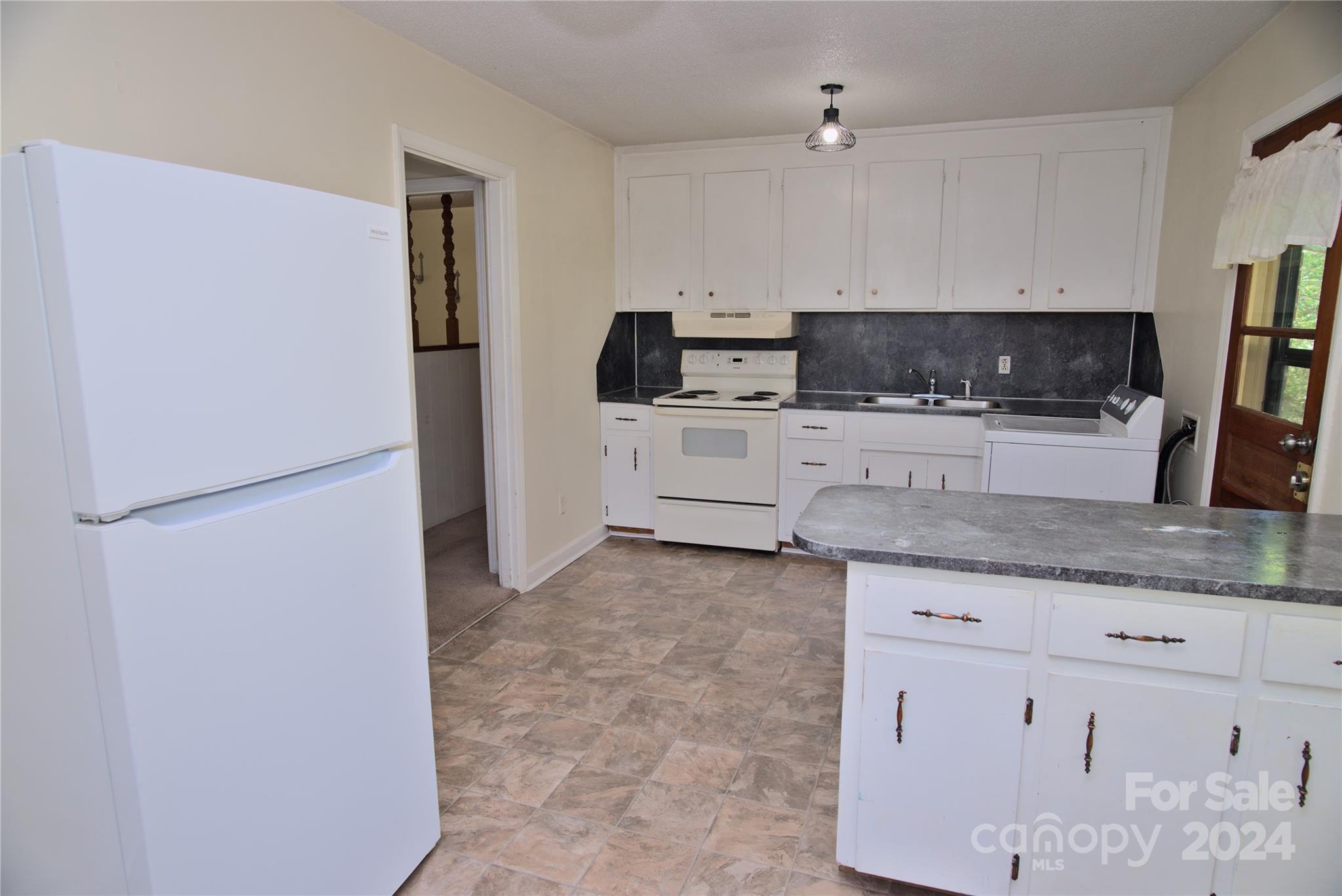 14903 Beatties Ford Road Huntersville, NC 28078 - Photo 10 of 25 a kitchen with stainless steel appliances granite countertop a refrigerator a stove a sink a microwave and cabinets