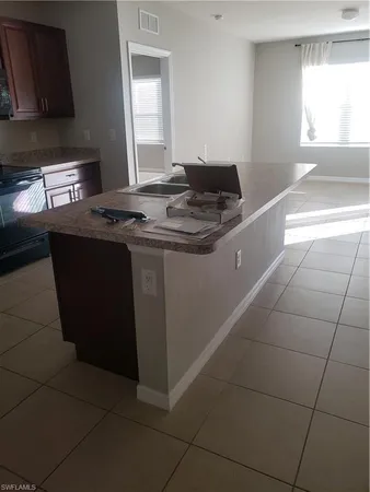 a bathroom with a granite countertop toilet sink and mirror