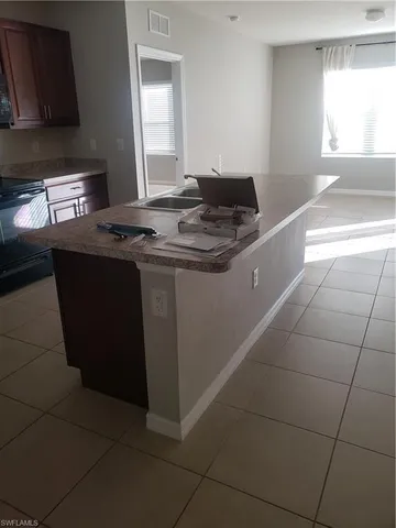 a bathroom with a granite countertop toilet sink and mirror