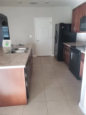 a view of a hallway and an empty room with a door