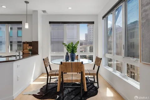 a kitchen with stainless steel appliances granite countertop a refrigerator a stove and a sink