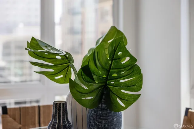 a kitchen with stainless steel appliances granite countertop a refrigerator a stove and a sink with wooden floor