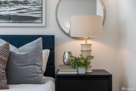 a bedroom with a bed and a painting on the wall