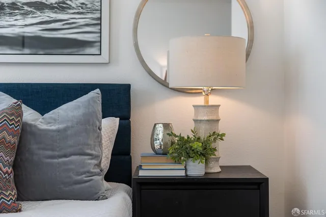 a bedroom with a bed and a painting on the wall