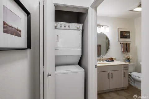 a spacious bedroom with a bed and painting on the wall