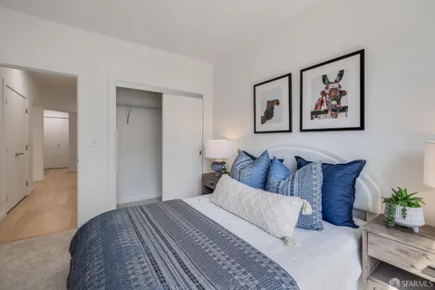 a view of a roof deck with table and chairs under an umbrella with wooden floor