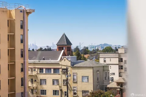 a living room with furniture and a dining table with kitchen view