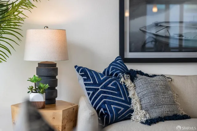 a living room with furniture flowerpot and wooden floor