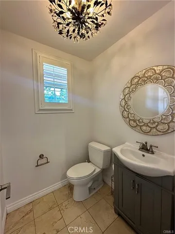 a bathroom with a sink mirror vanity and toilet