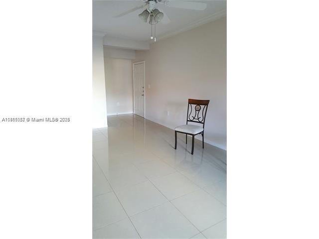 140 Southwest 117th Avenue, Unit 4101 Pembroke Pines, FL 33025 - Photo 6 of 8 a view of an empty room with a window