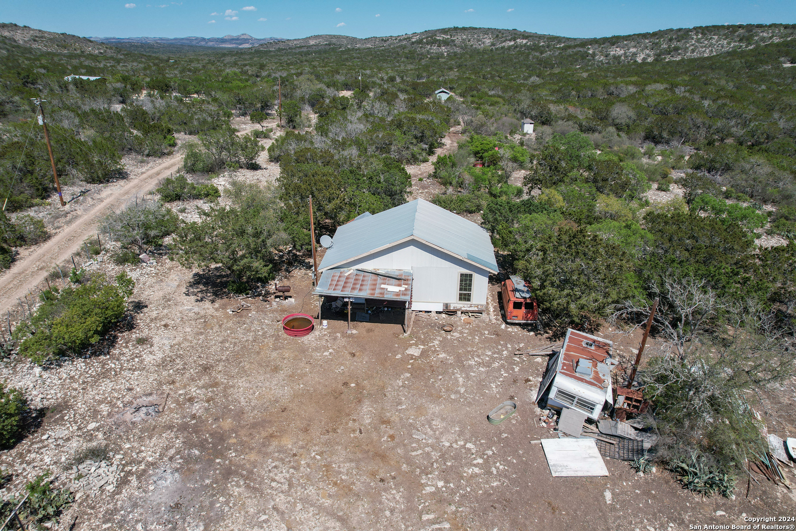an aerial view of a house with a yard