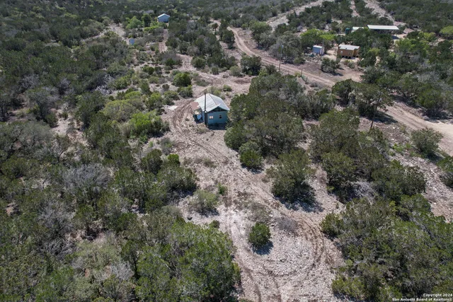 an aerial view of house with yard and outdoor seating