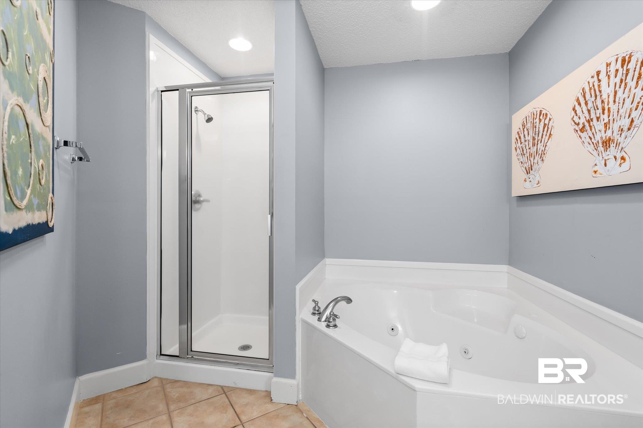 27580 Canal Road, Unit 1423 Orange Beach, AL 36561 - Photo 13 of 34 Primary bathroom featuring tile patterned flooring, jacuzzi tub and separate shower.