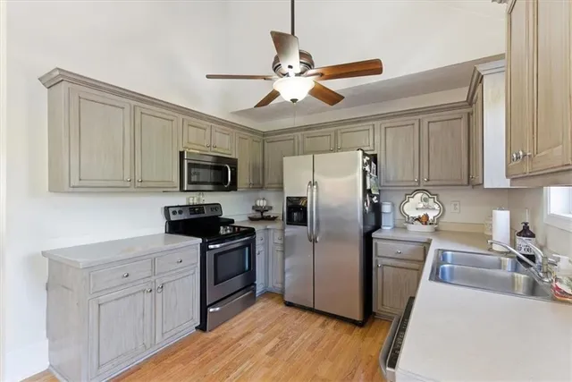 a kitchen with appliances cabinets a sink and a counter top space
