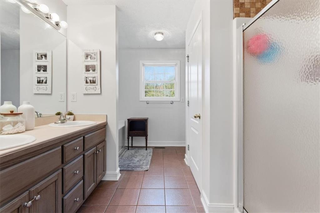 941 Grassdale Road Northwest Cartersville, GA 30121 - Photo 17 of 42 a spacious bathroom with a bathtub sink and mirror