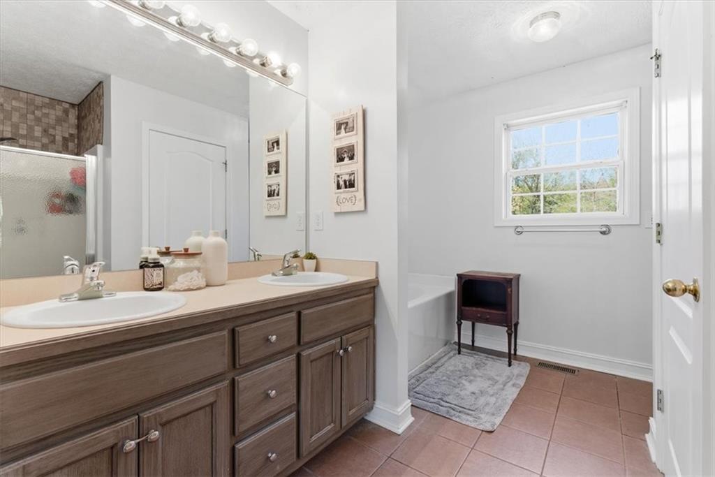 941 Grassdale Road Northwest Cartersville, GA 30121 - Photo 18 of 42 a spacious bathroom with a double vanity sink and a mirror