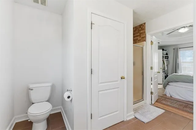 a bathroom with a toilet and a shower