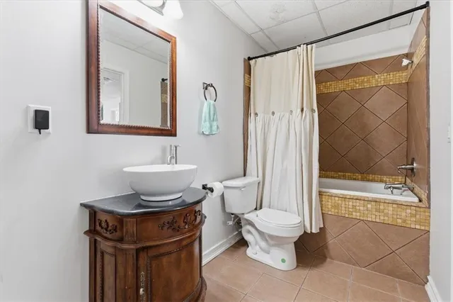 a bathroom with a toilet a sink and a mirror