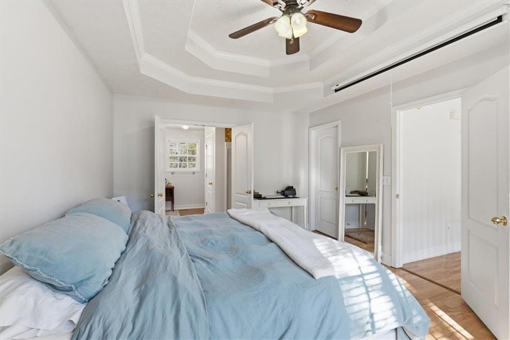 941 Grassdale Road Northwest Cartersville, GA 30121 - Photo 6 of 42 a spacious bedroom with a bed and a chandelier