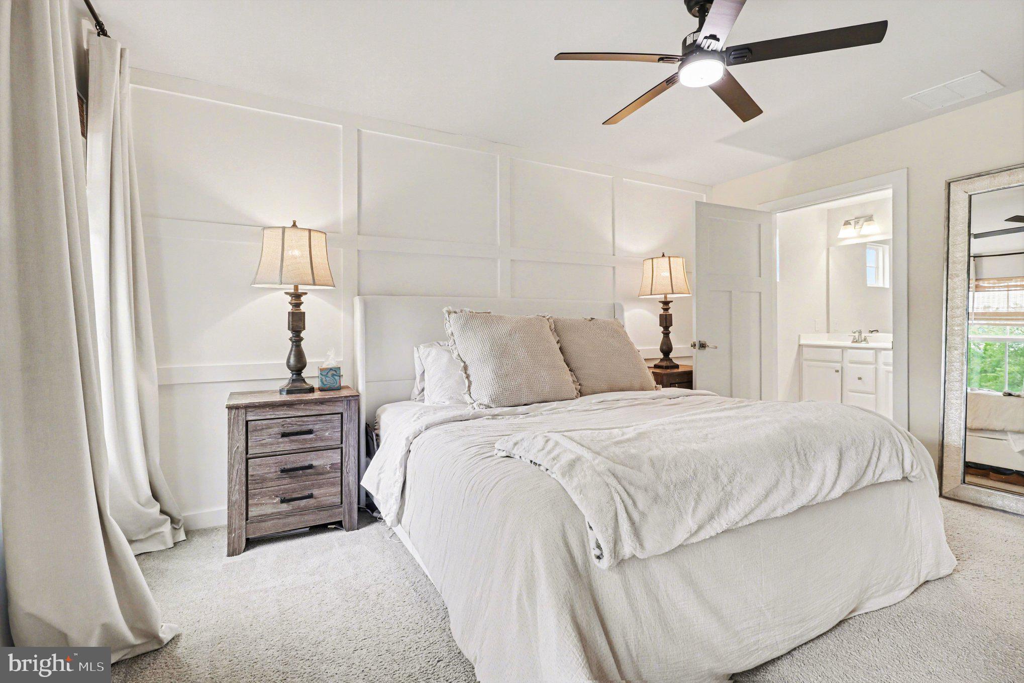 7202 Parchment Circle Ruther Glen, VA 22546 - Photo 14 of 30 a bedroom with a bed and a chandelier
