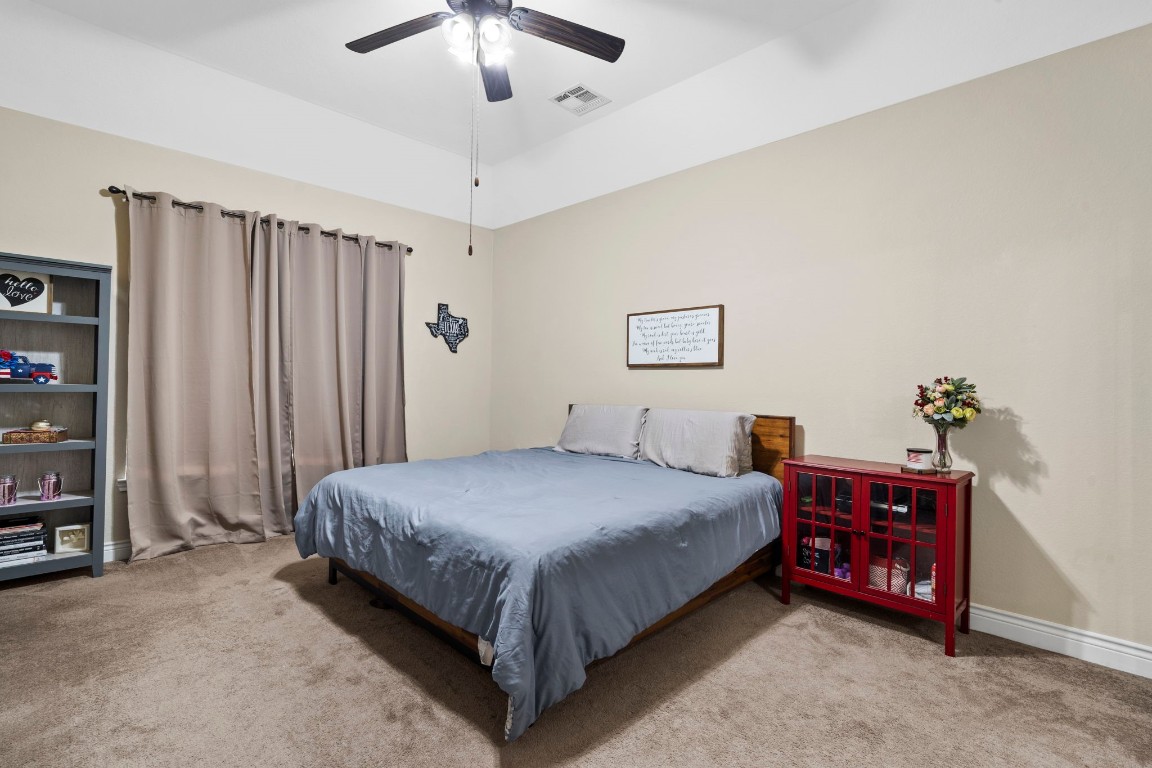 4926 Magnolia Bend Drive Rosharon, TX 77583 - Photo 15 of 27 a bedroom with a bed and a chandelier