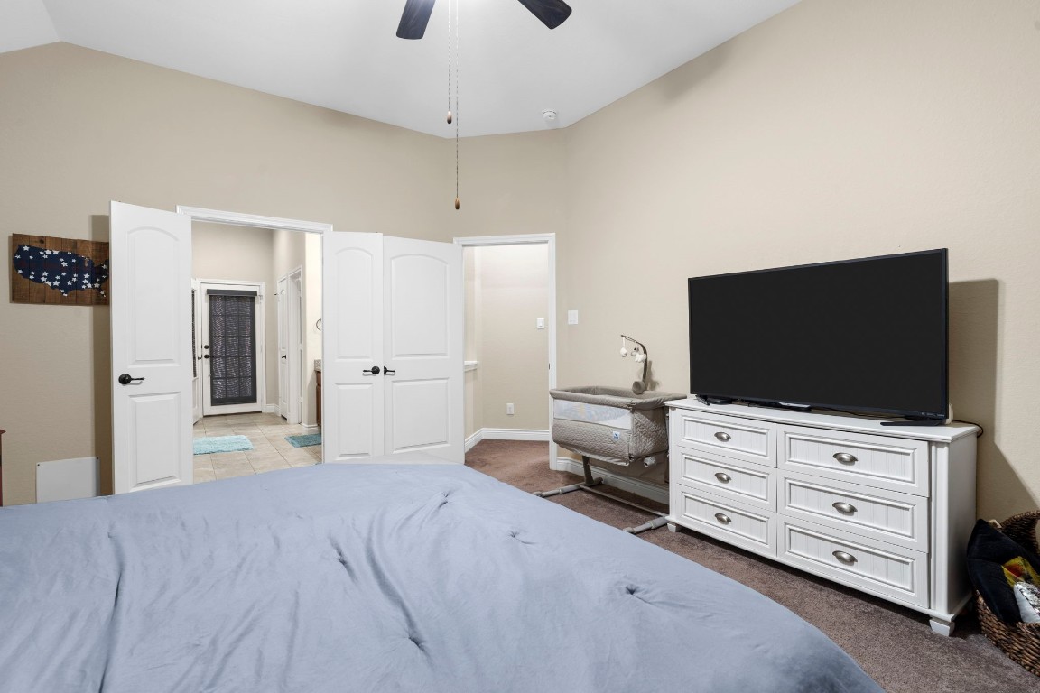 4926 Magnolia Bend Drive Rosharon, TX 77583 - Photo 16 of 27 a bedroom with furniture and a flat screen tv