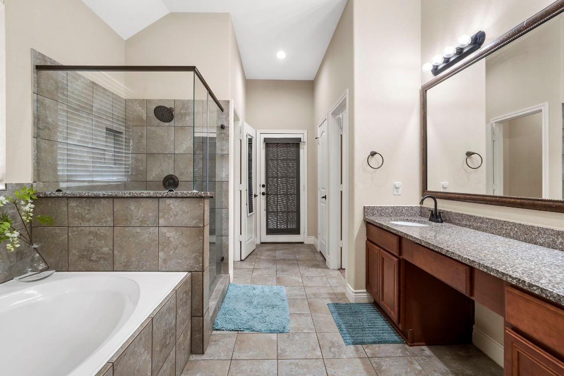 4926 Magnolia Bend Drive Rosharon, TX 77583 - Photo 17 of 27 a bathroom with a granite countertop bathtub a sink and a shower