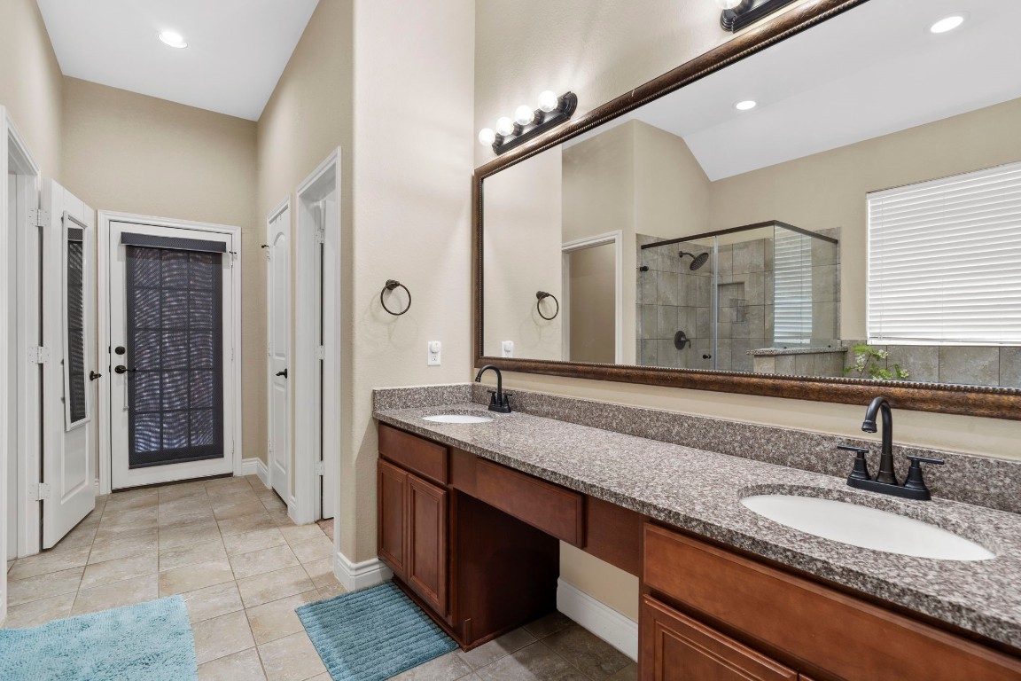 4926 Magnolia Bend Drive Rosharon, TX 77583 - Photo 18 of 27 a bathroom with a granite countertop sink and a mirror