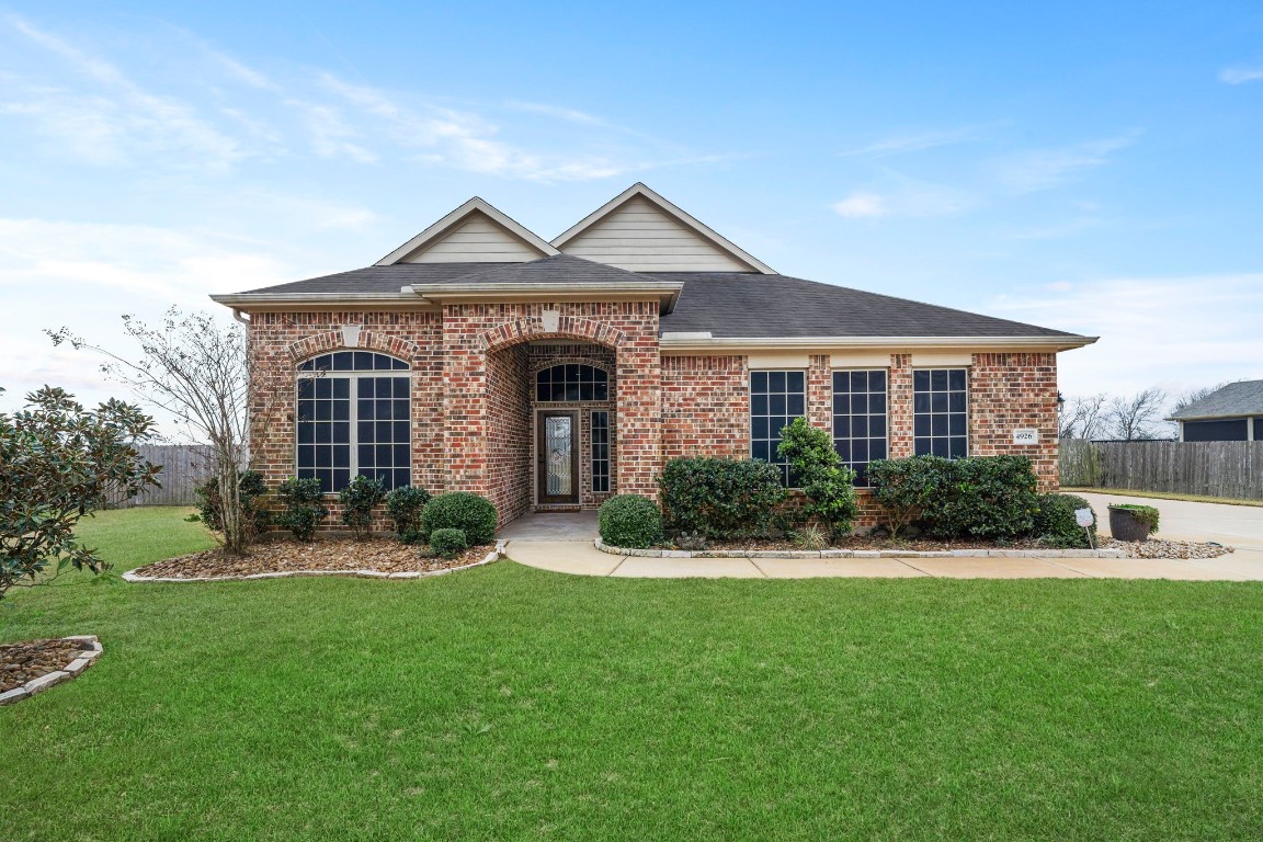 4926 Magnolia Bend Drive Rosharon, TX 77583 - Photo 2 of 27 a front view of a house with a yard and garage