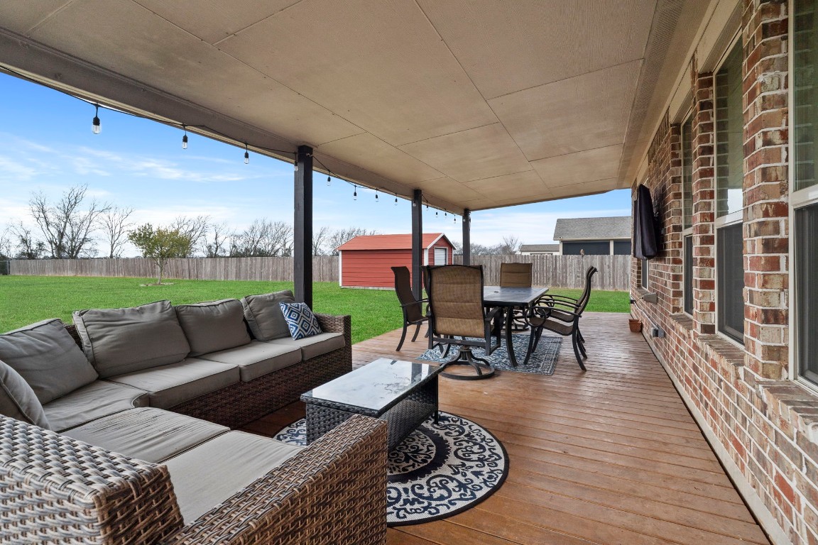 4926 Magnolia Bend Drive Rosharon, TX 77583 - Photo 24 of 27 a view of a patio with couches chairs dining table and chairs with wooden floor