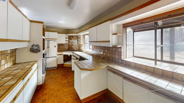 a kitchen with stainless steel appliances granite countertop sink stove and cabinets