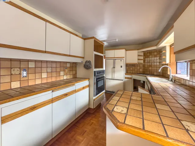 a kitchen with stainless steel appliances kitchen island granite countertop a sink and cabinets