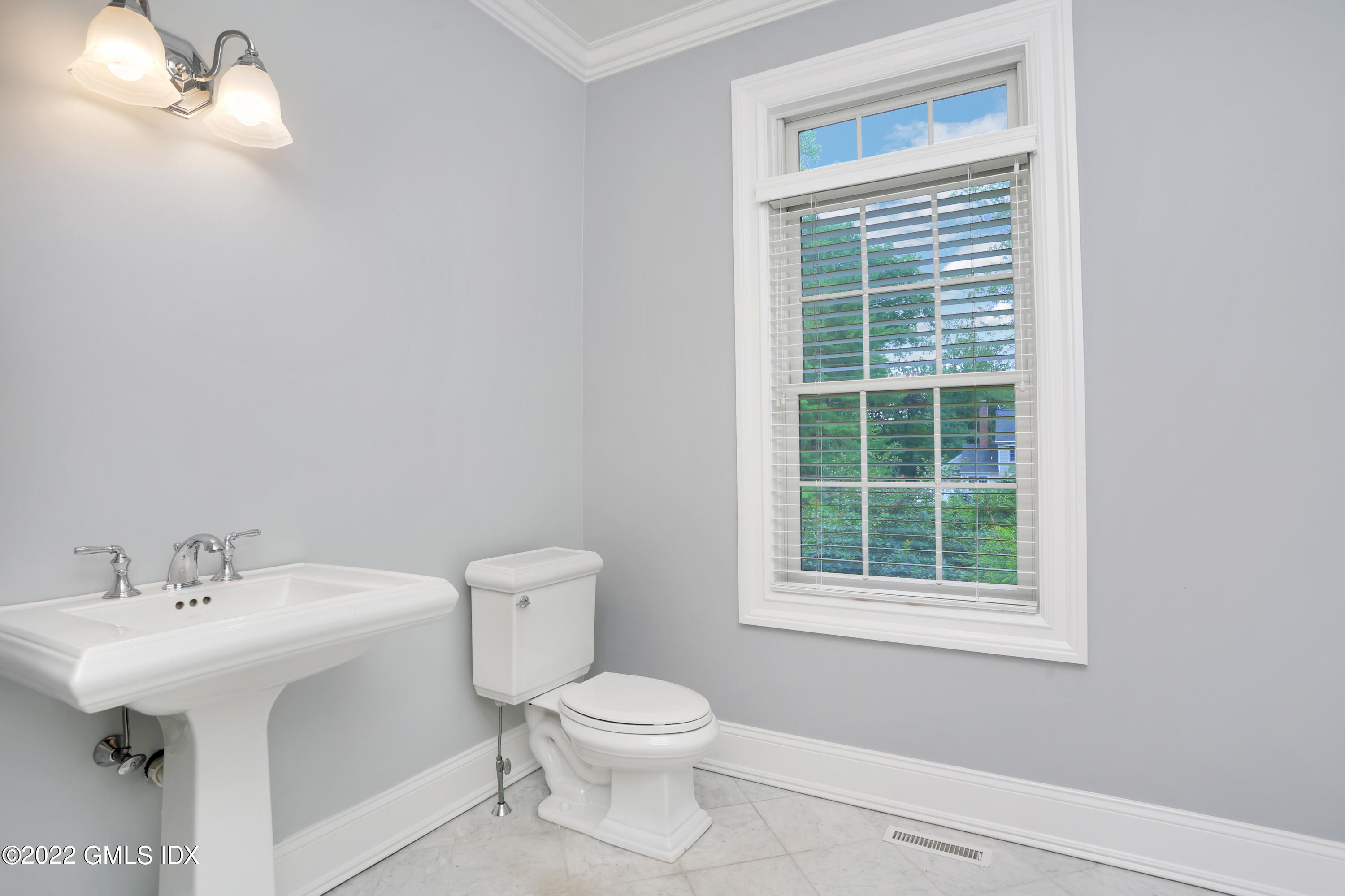 19 West Hill Road Stamford, CT 06902 - Photo 13 of 25 a bathroom with a sink a toilet and a window