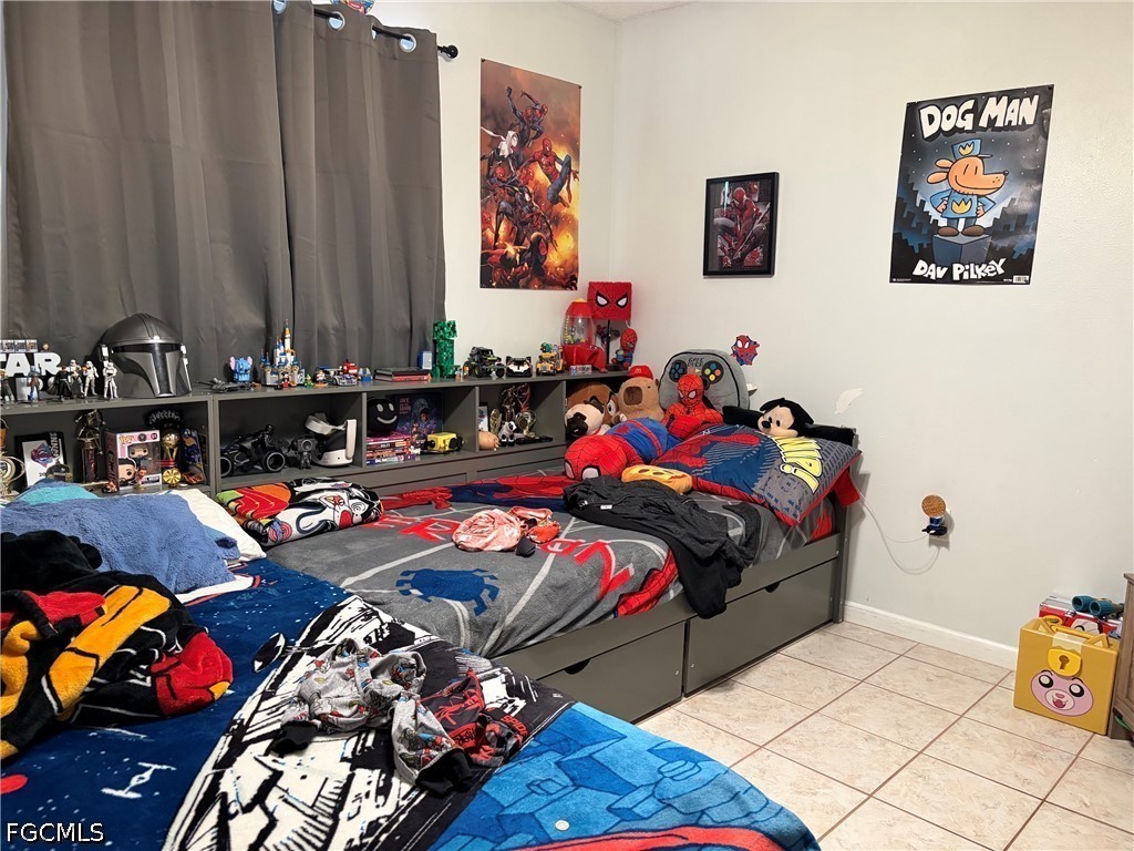 2175 Twin Brooks Road North Fort Myers, FL 33917 - Photo 23 of 27 a bedroom with bed and a couch