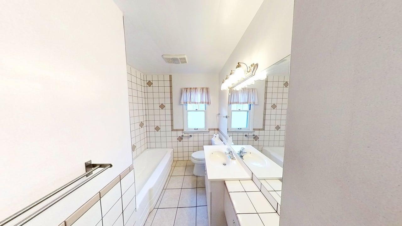 509 West Williams Street Kankakee, IL 60901 - Photo 16 of 26 a spacious bathroom with a double vanity sink and a mirror
