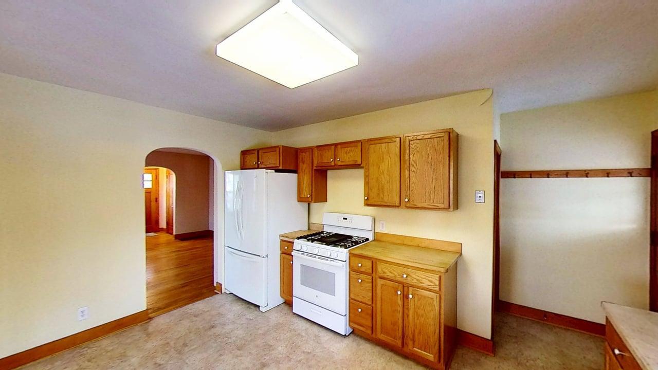 509 West Williams Street Kankakee, IL 60901 - Photo 9 of 26 a view of a kitchen with fridge and wooden floor