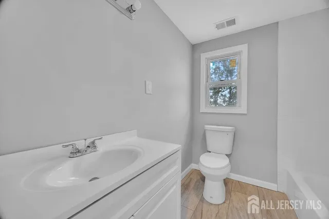 a white toilet sitting next to a bathroom sink