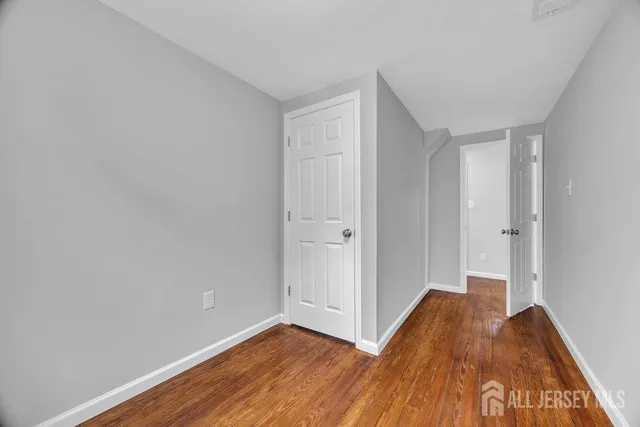 a view of a room with wooden floor