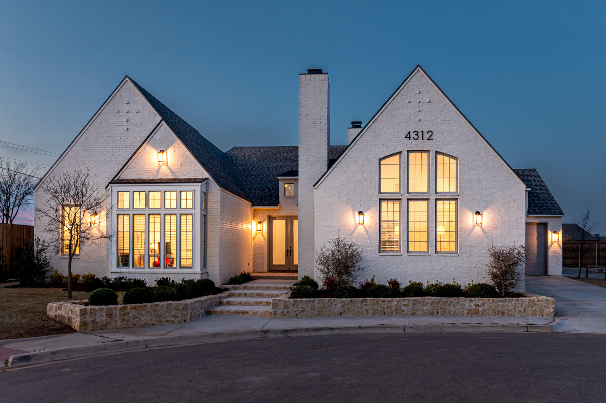 an entrance view of a house with a yard