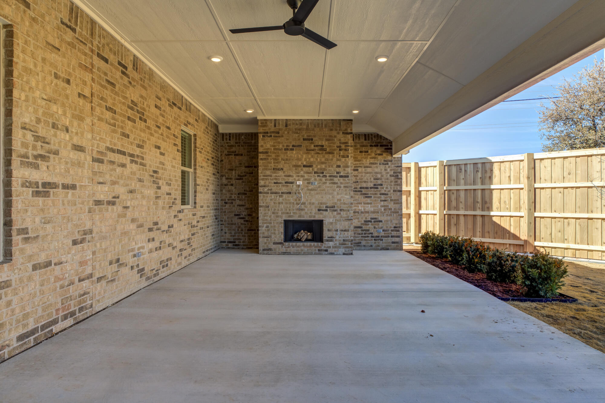 4312 136th Street Lubbock, TX 79423 - Photo 3 of 7 an empty room with a fireplace and wooden floor