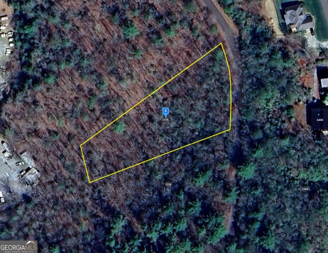 a view of a yard with a wooden fence