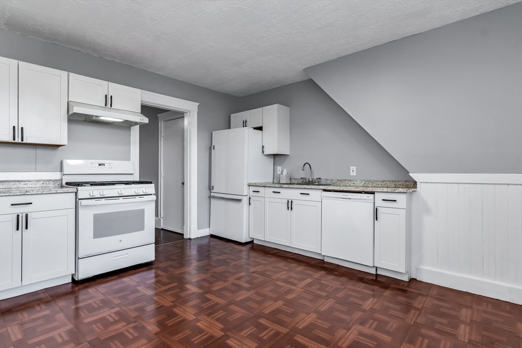 88 Congress Street, Unit 3 Salem, MA 01970 - Photo 11 of 31 a kitchen with white cabinets and white appliances