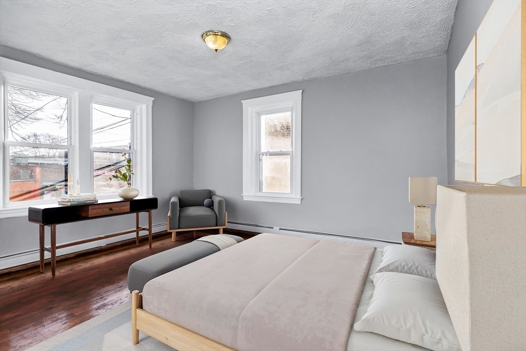 88 Congress Street, Unit 3 Salem, MA 01970 - Photo 13 of 31 a bedroom with a bed and a large window with wooden floor